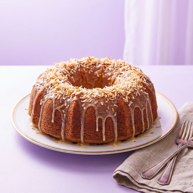 Coconut rum cake covered in toasted coconut flakes